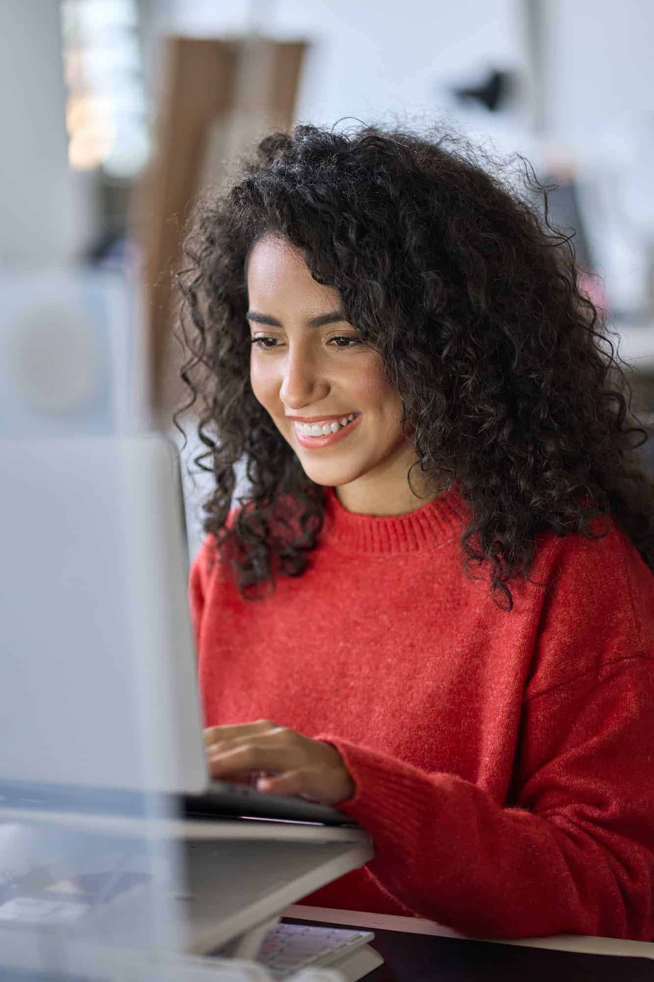 young happy latin woman student elearning using laptop vertical shot